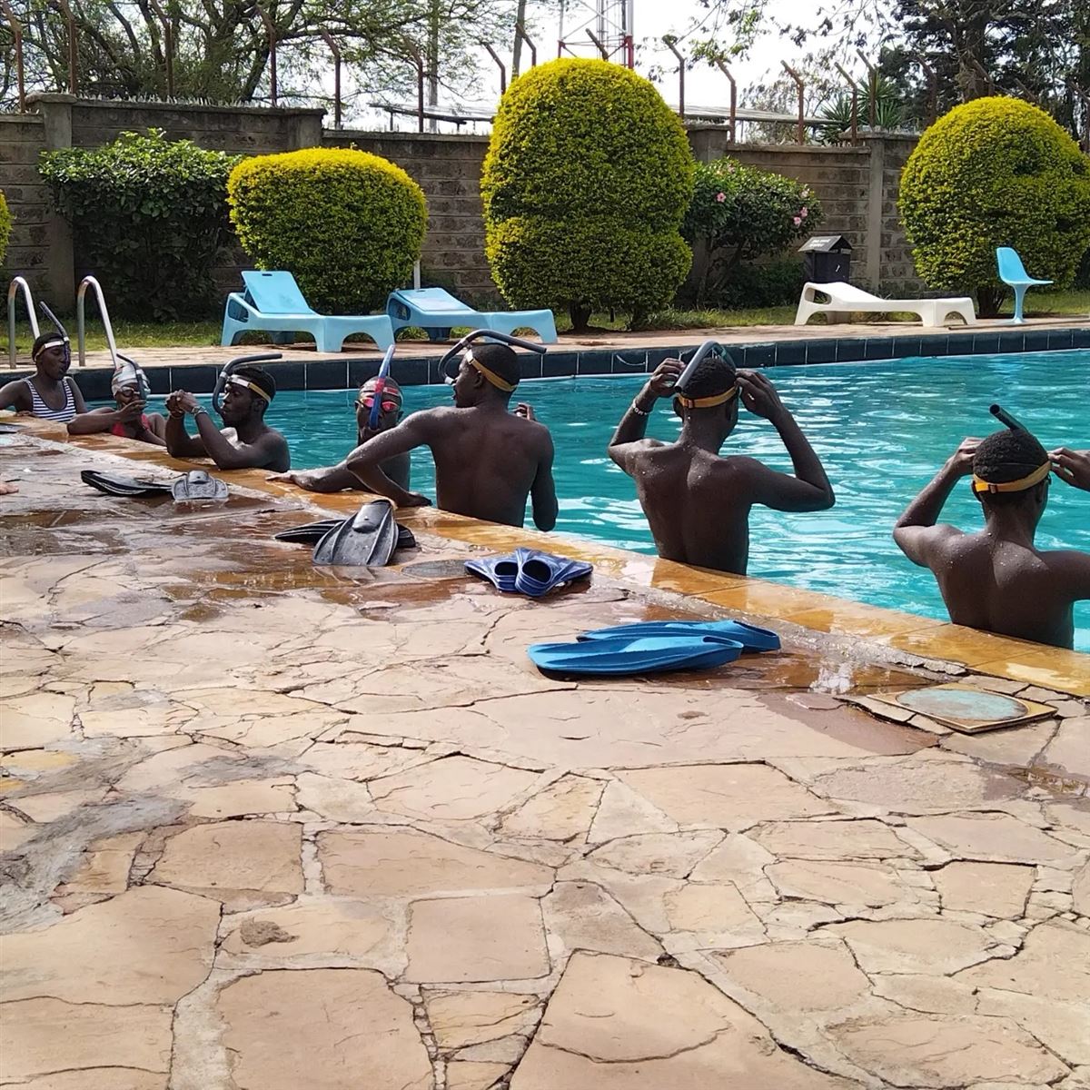 Swimmers putting on centre snorkels in the pool