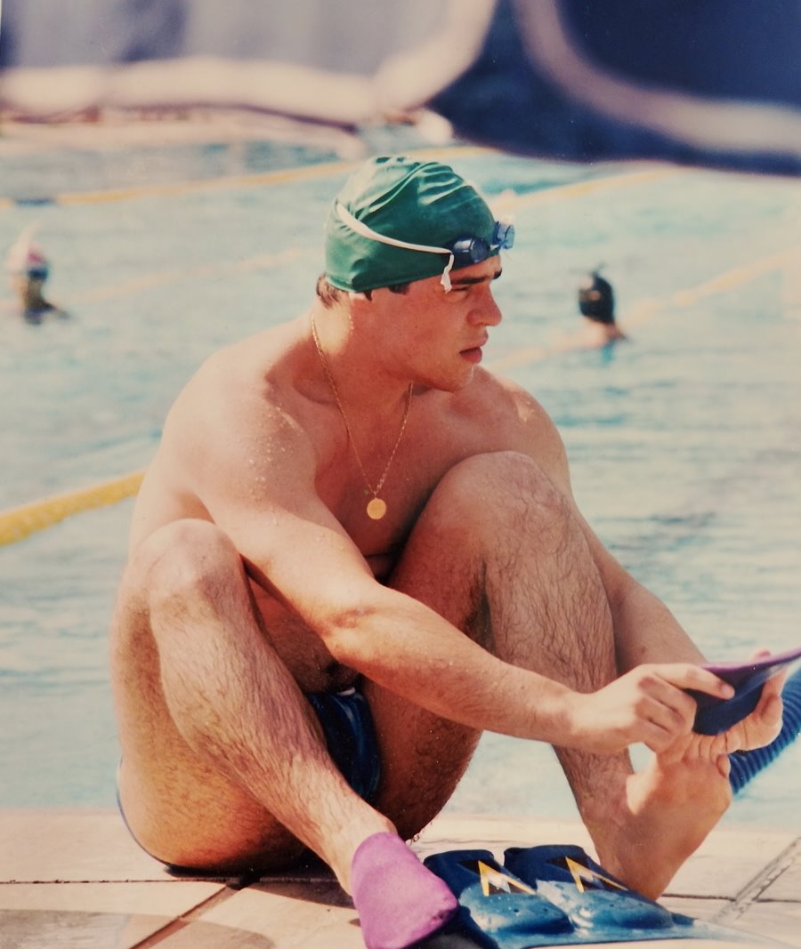Rubes Levada putting on his fins on the pool deck, late 1990s